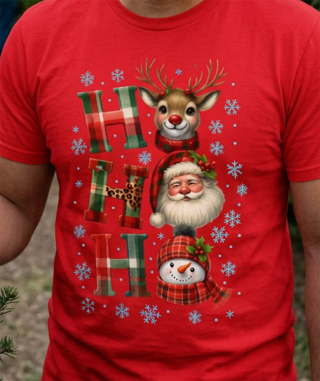Close-up of red Christmas graphic tee showing festive holiday characters and colorful winter snowflakes.