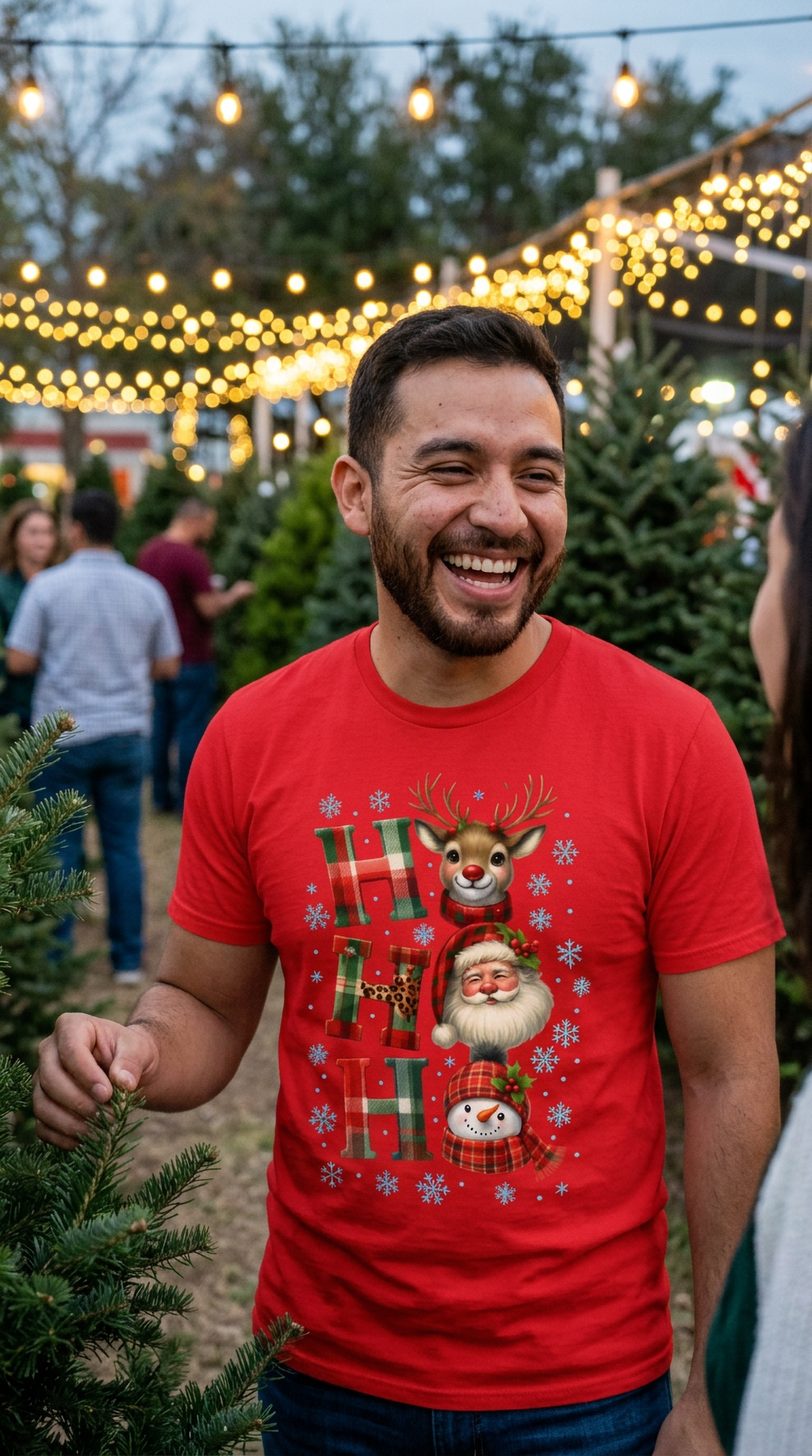 Man wearing red Ho Ho Ho Christmas graphic shirt outdoors at a festive holiday event.
