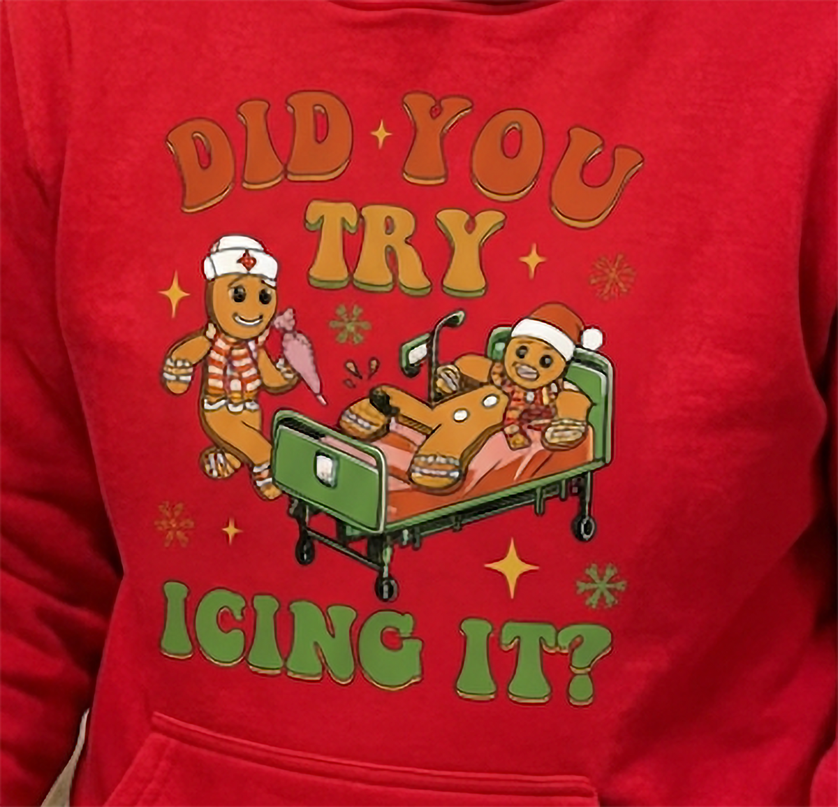 Close-up of Did You Try Icing It gingerbread medical graphic on red hoodie