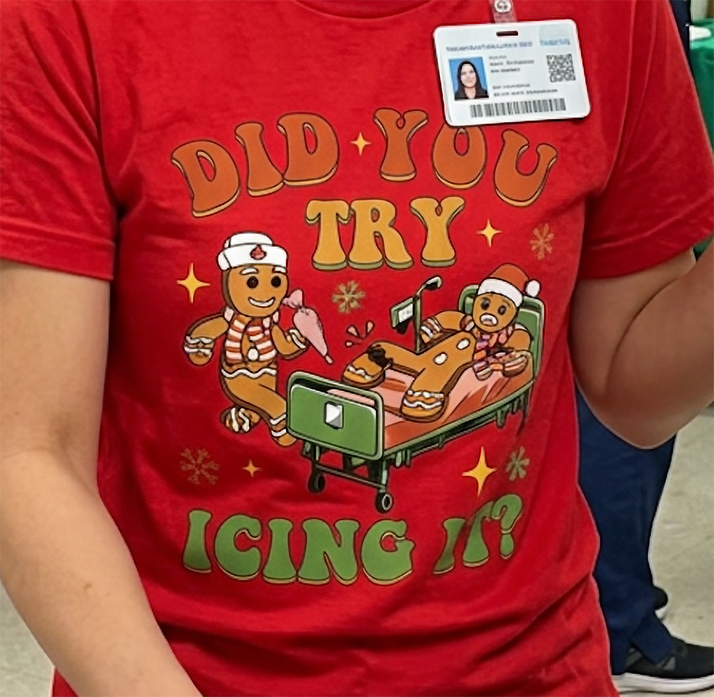 Close-up of festive gingerbread medical humor graphic on a red Christmas t-shirt.