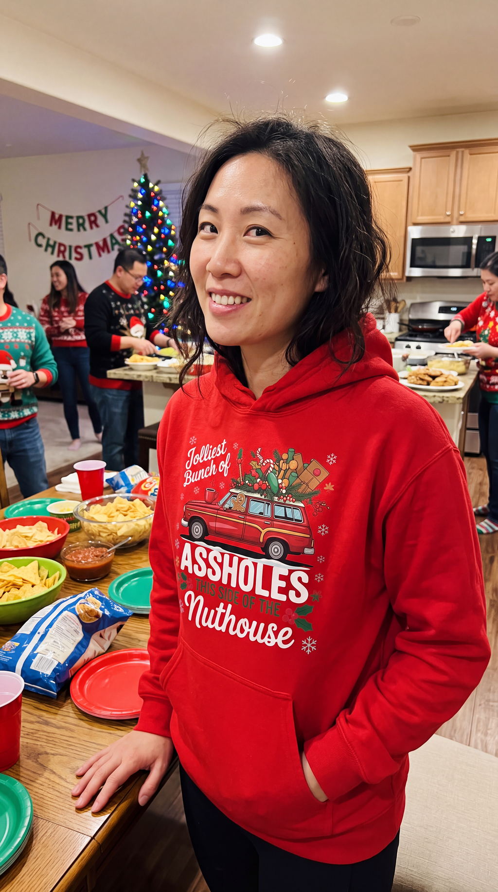 Woman wearing red funny family Christmas hoodie with Jolliest Bunch holiday design