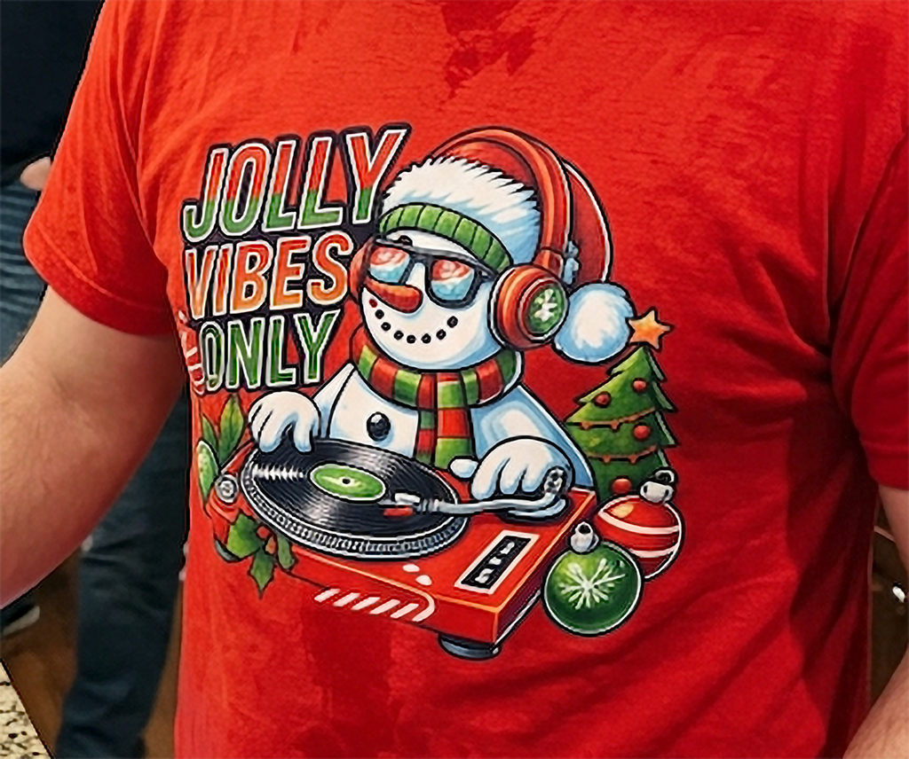 Red Close-Up: Close-up of Jolly Vibes Only snowman DJ Christmas artwork on a red t-shirt.