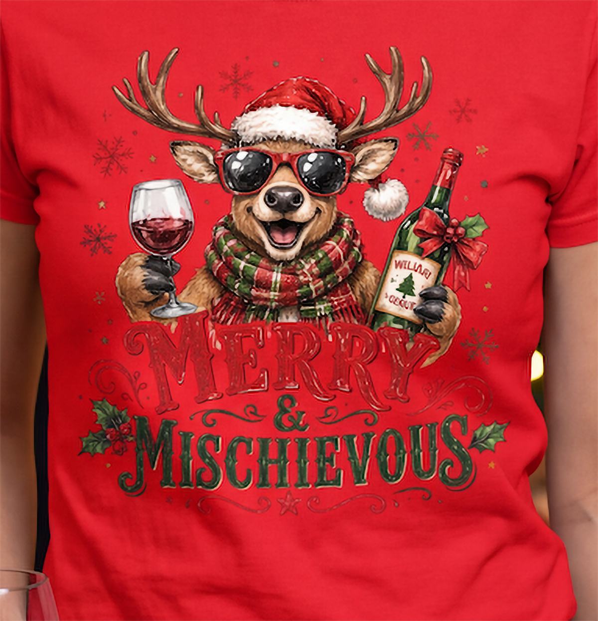 Close-up of red Merry & Mischievous Christmas shirt showing festive reindeer wine design.