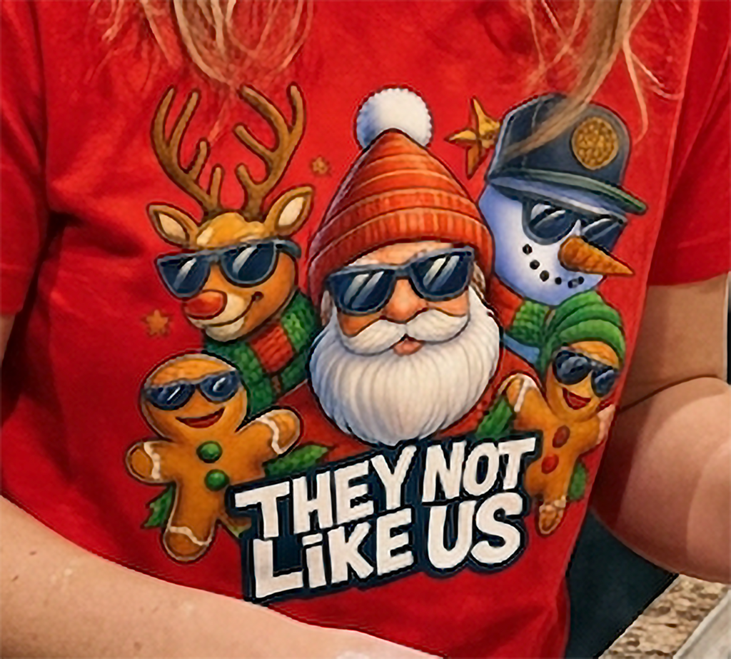 Red Close-Up: Detailed view of They Not Like Us Christmas graphic printed on a red holiday t-shirt with colorful festive characters.