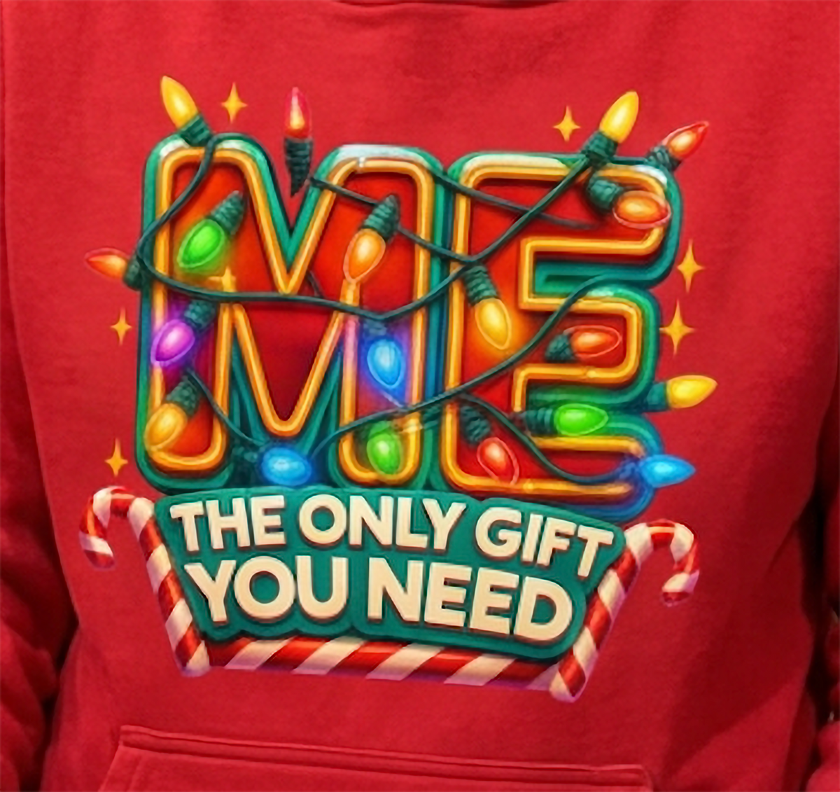 Close-up of Me The Only Gift You Need Christmas graphic on red hoodie