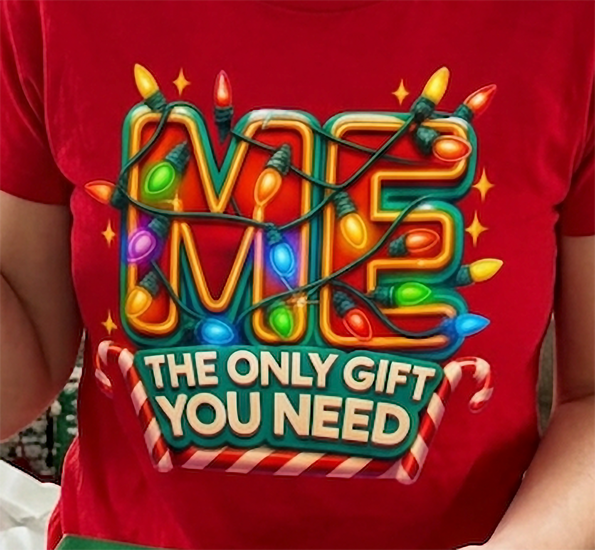 Red Design Close-Up: Close-up of the colorful Me The Only Gift You Need Christmas graphic printed on vibrant red fabric.