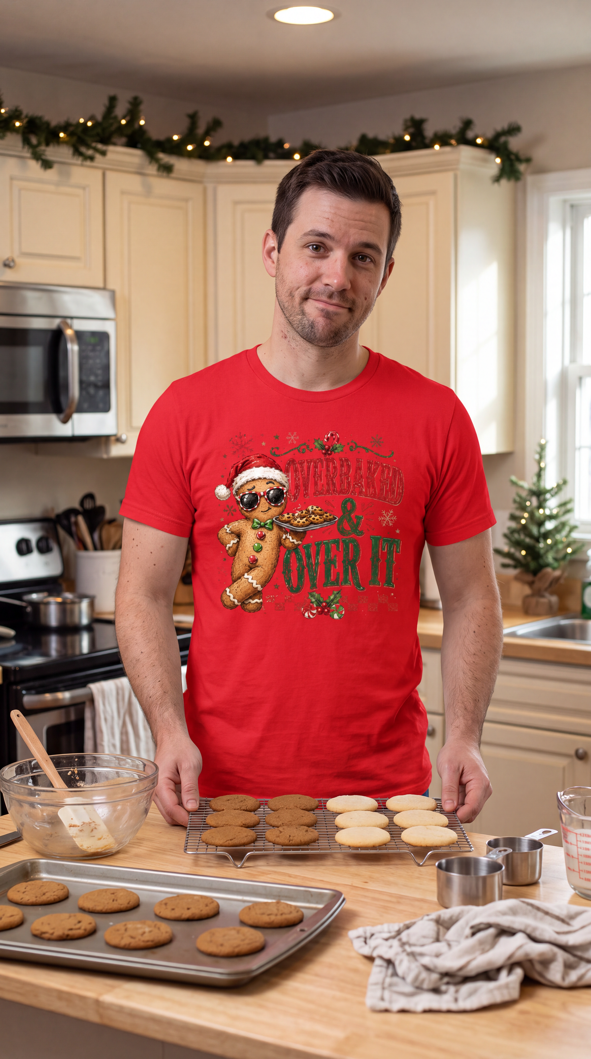 Man wearing red funny Christmas baking shirt featuring festive gingerbread man and cookies.