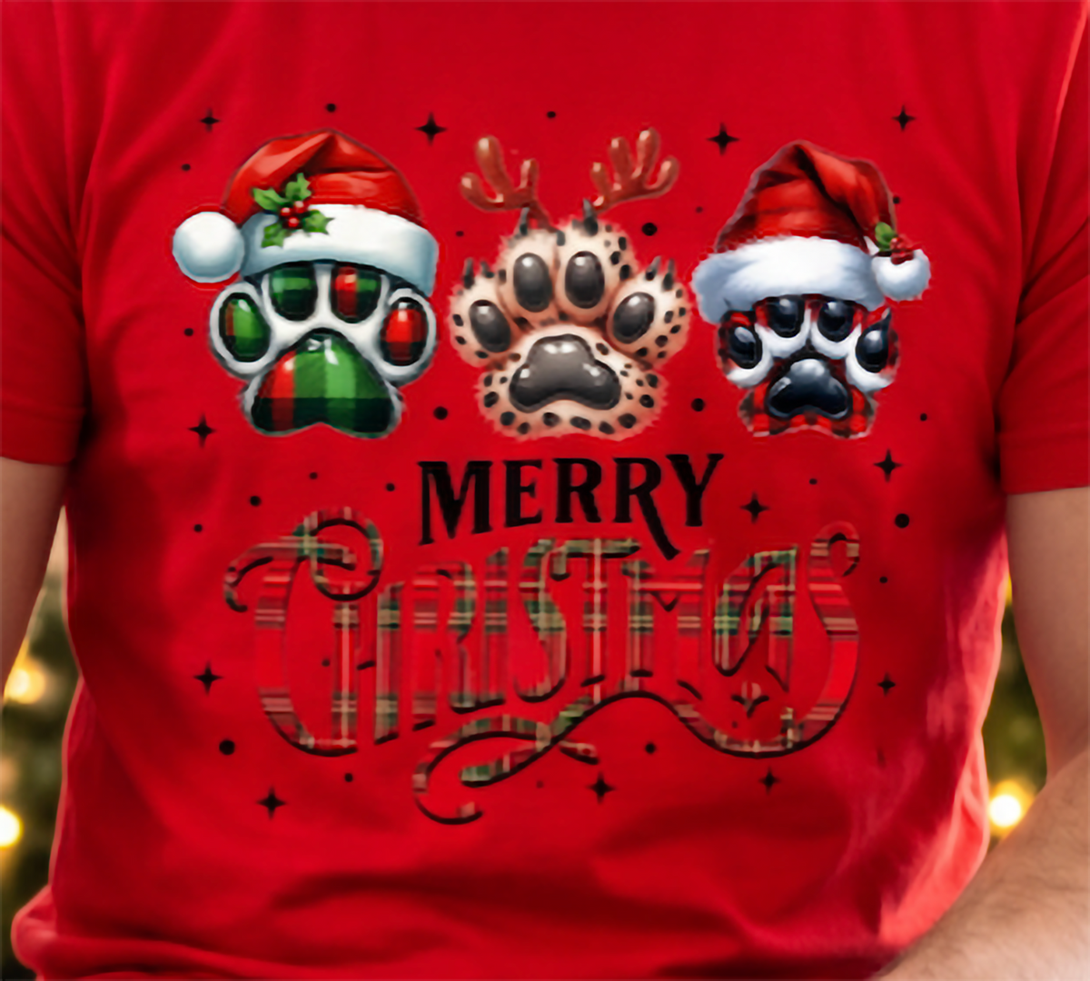Close-up of red Merry Christmas dog lover shirt with three holiday paw prints and Christmas lettering.