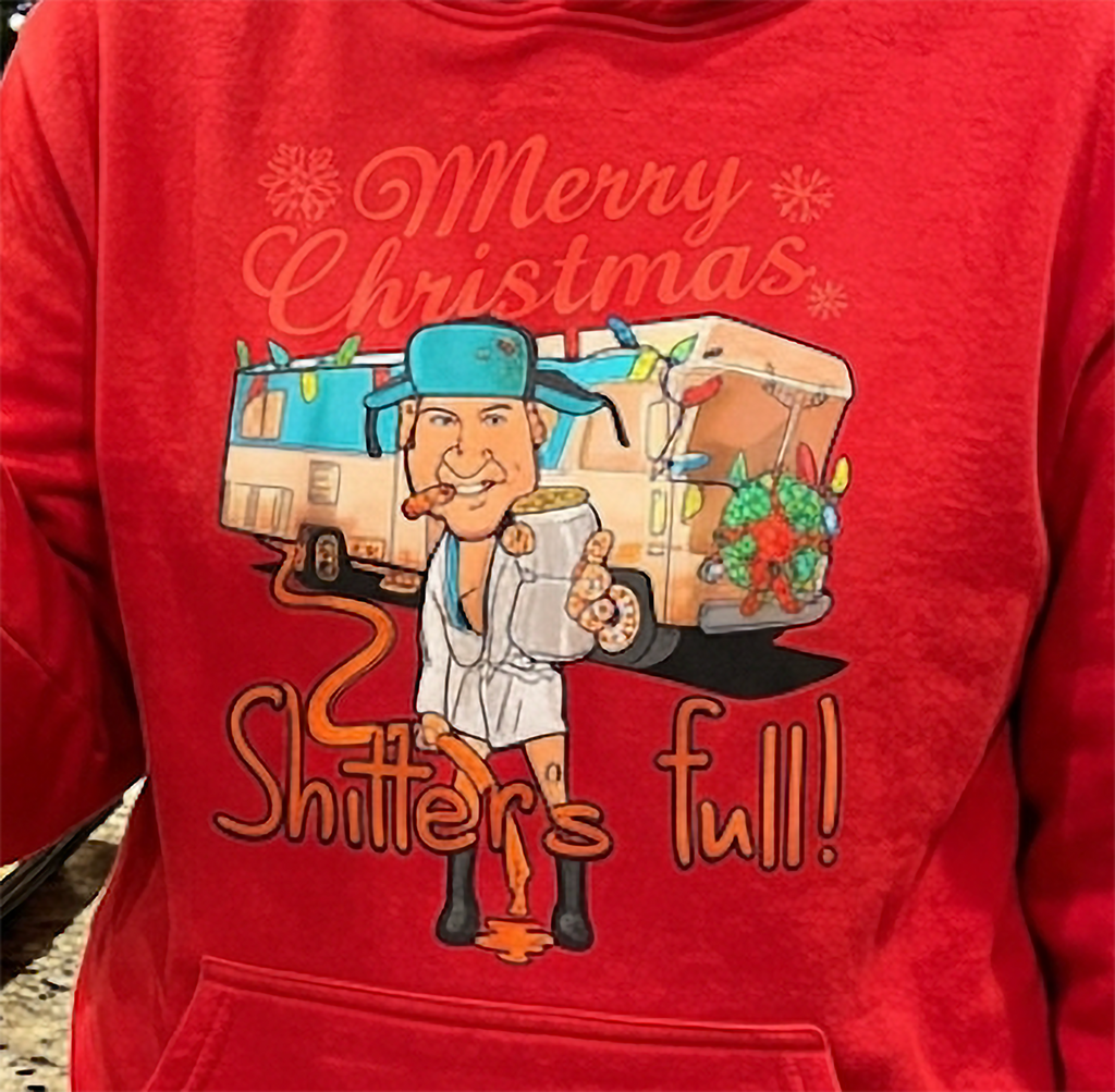 Close-up of Shitter’s Full Cousin Eddie RV Christmas graphic on red hoodie