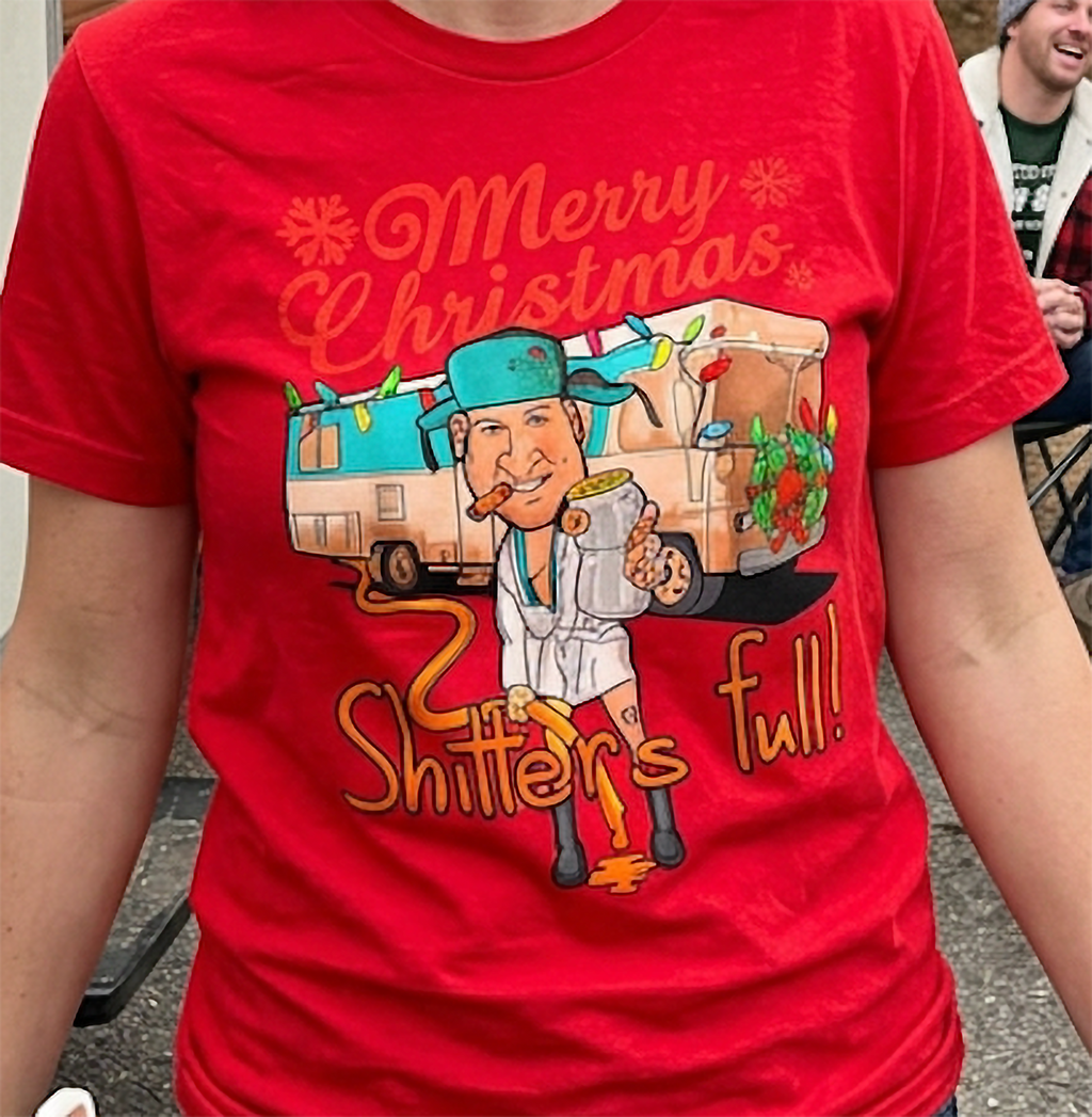 Red Design Close-Up: Close-up of red Christmas graphic tee showing festive camper illustration, Christmas lights, and humorous holiday saying.