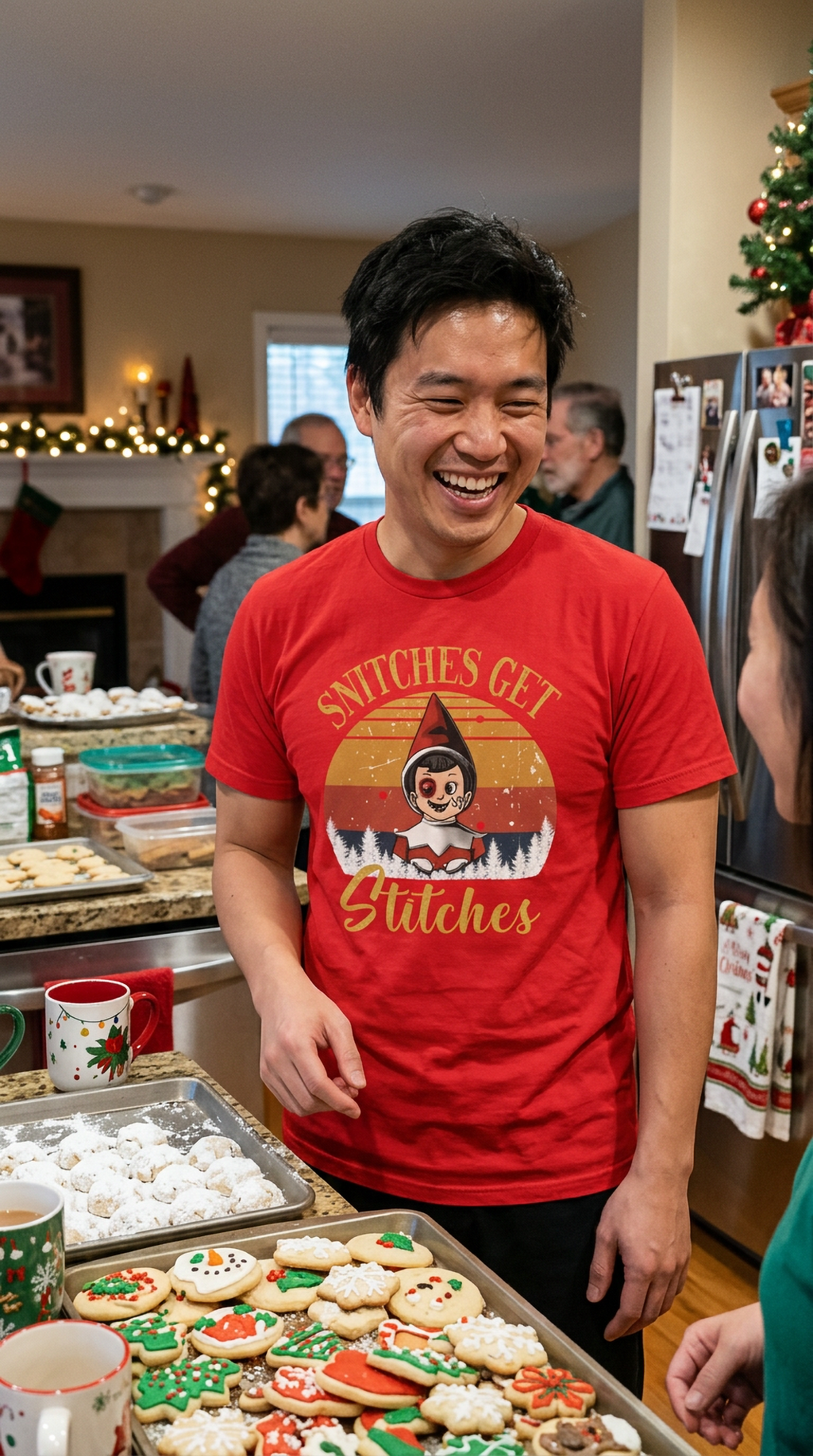 Man wearing a red funny Christmas elf t-shirt at a holiday gathering with festive decorations.