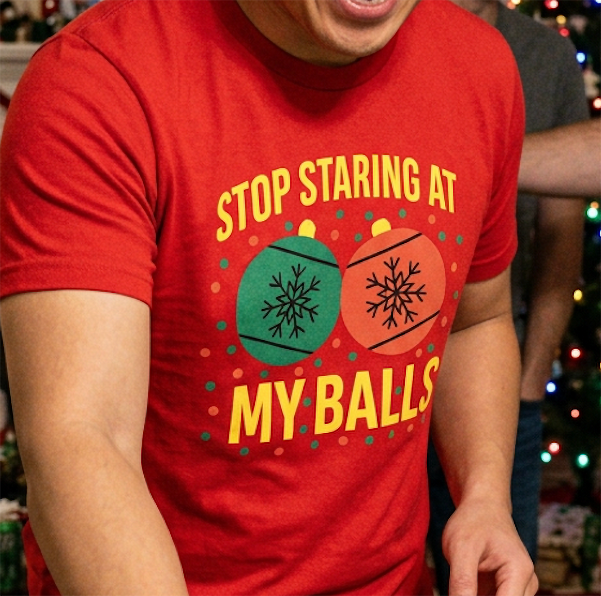 Close-up of red adult Christmas humor shirt featuring bold yellow lettering and festive ornament graphics.