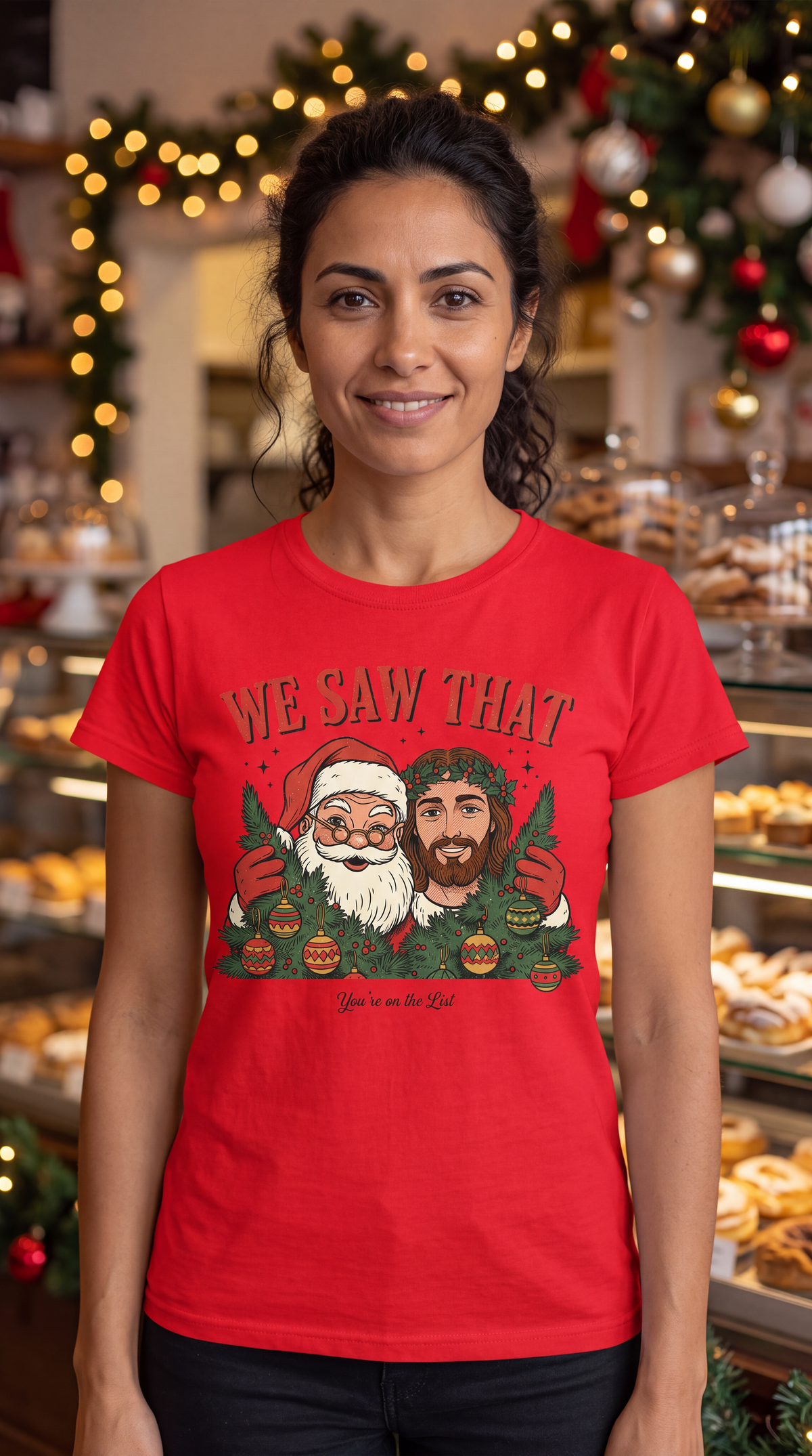 Woman wearing red We Saw That Santa and Jesus funny Christmas graphic shirt