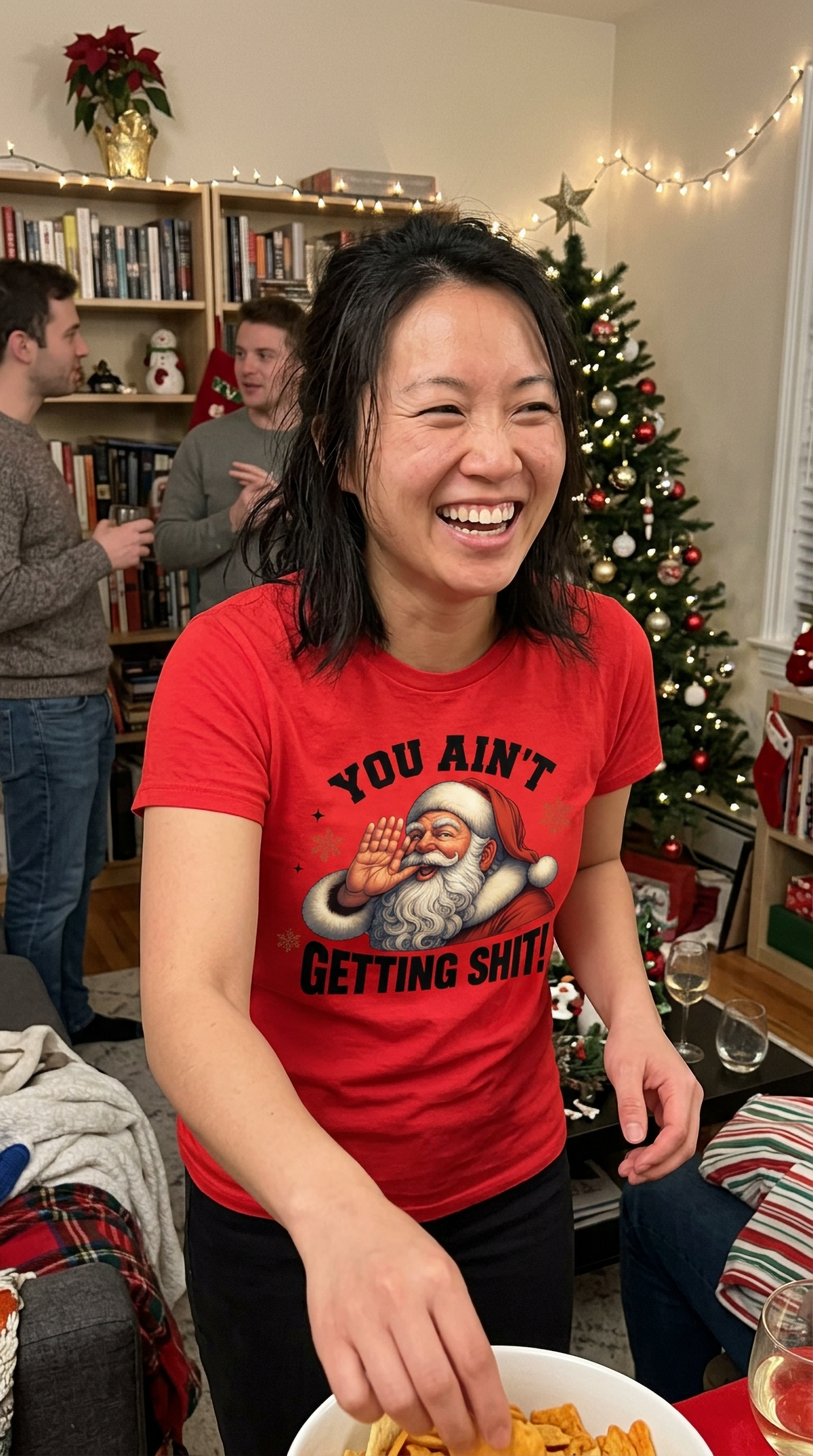 Red Lifestyle: Woman wearing a red You Ain't Getting Shit Christmas graphic t-shirt at a festive holiday gathering.