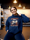 Woman wearing navy “Rough Sets Only Don’t Go Soft On Me” gym hoodie in a workout setting