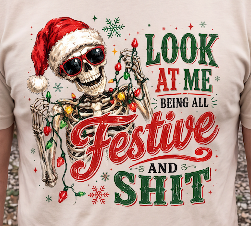 Sand close-up: Close-up of funny festive skeleton Christmas graphic printed on sand colored shirt.