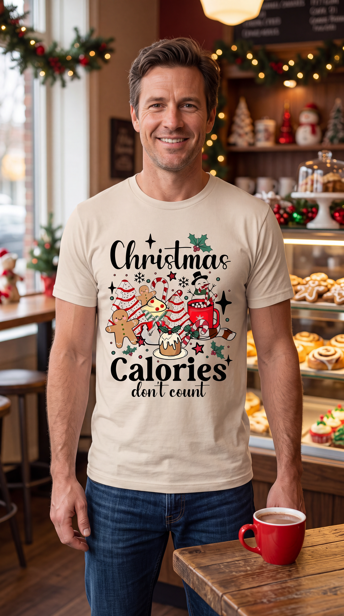 Man wearing sand Christmas Calories Don’t Count shirt featuring cookies, cocoa and festive Christmas treats.
