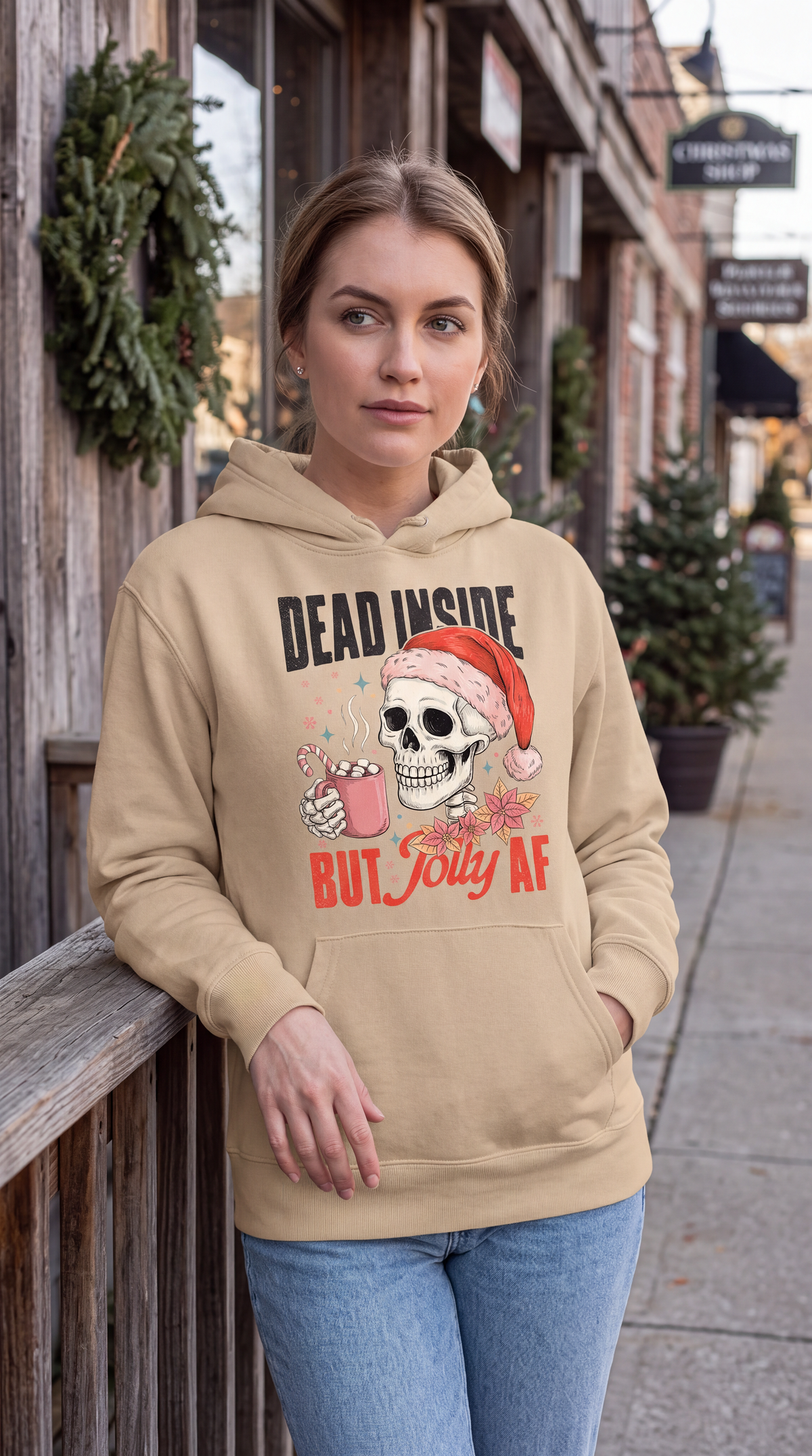 Woman wearing sand Christmas skeleton hoodie with Dead Inside But Jolly AF design