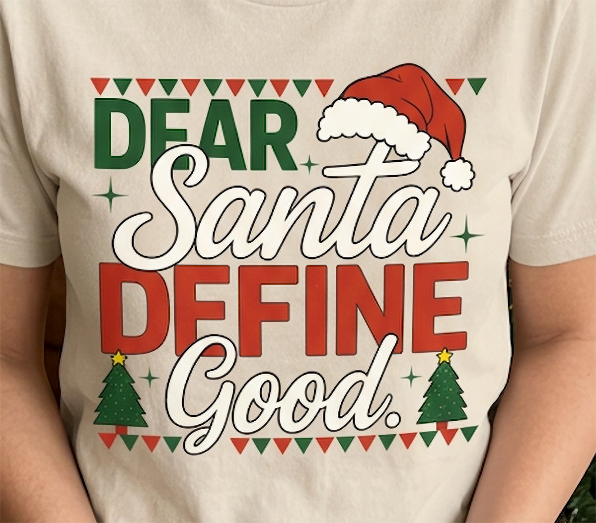 Sand Close-Up: Detailed close-up of the Dear Santa Define Good design printed on a sand-colored unisex Christmas t-shirt.