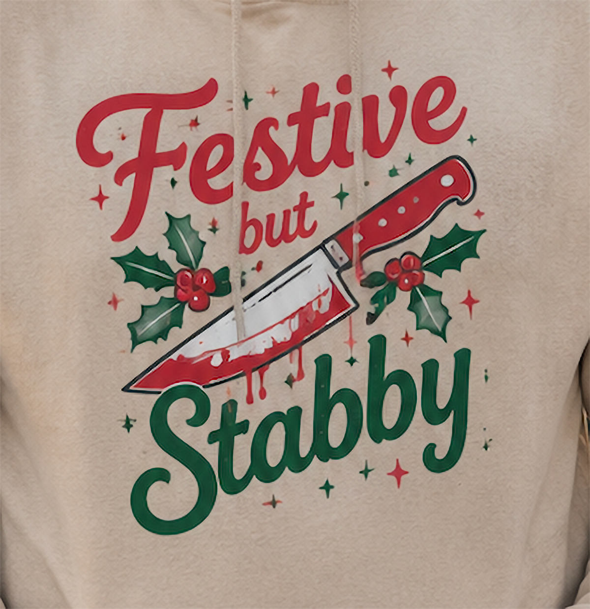 Close-up of sand sarcastic Christmas hoodie with Festive But Stabby design