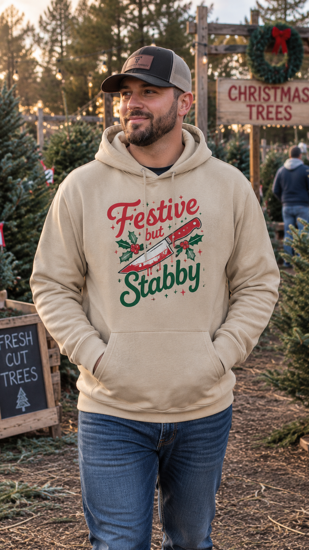 Man wearing sand Festive But Stabby dark humor Christmas hoodie