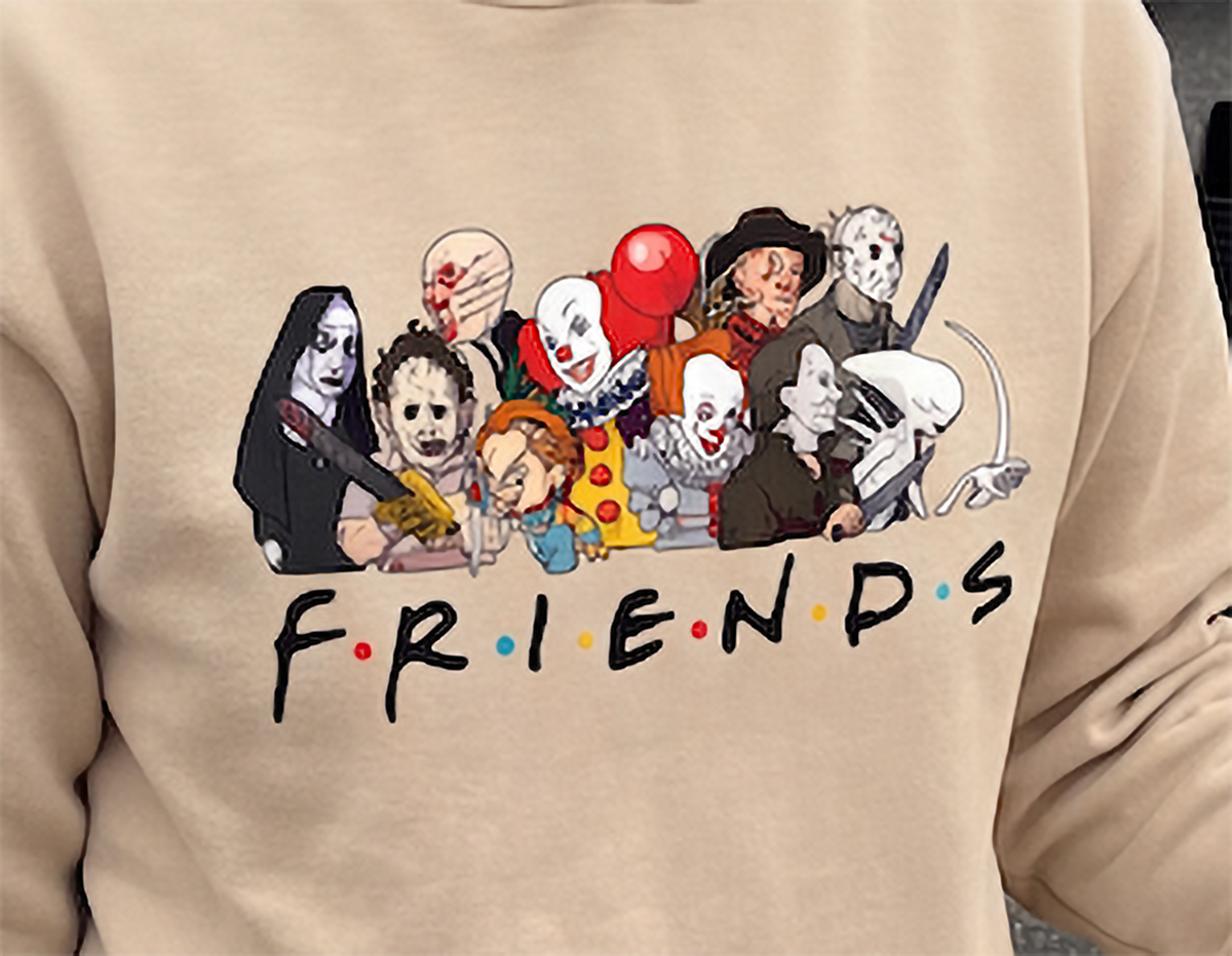 Close-up of sand Horror Friends Halloween hoodie featuring horror movie characters