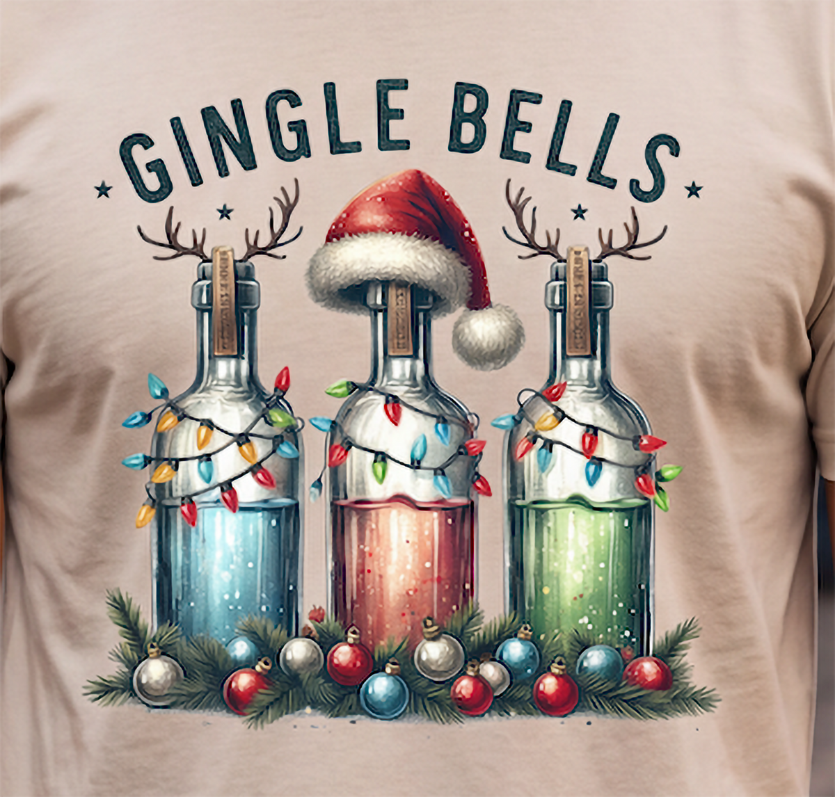 Close-up of Gingle Bells Christmas cocktail graphic on sand shirt