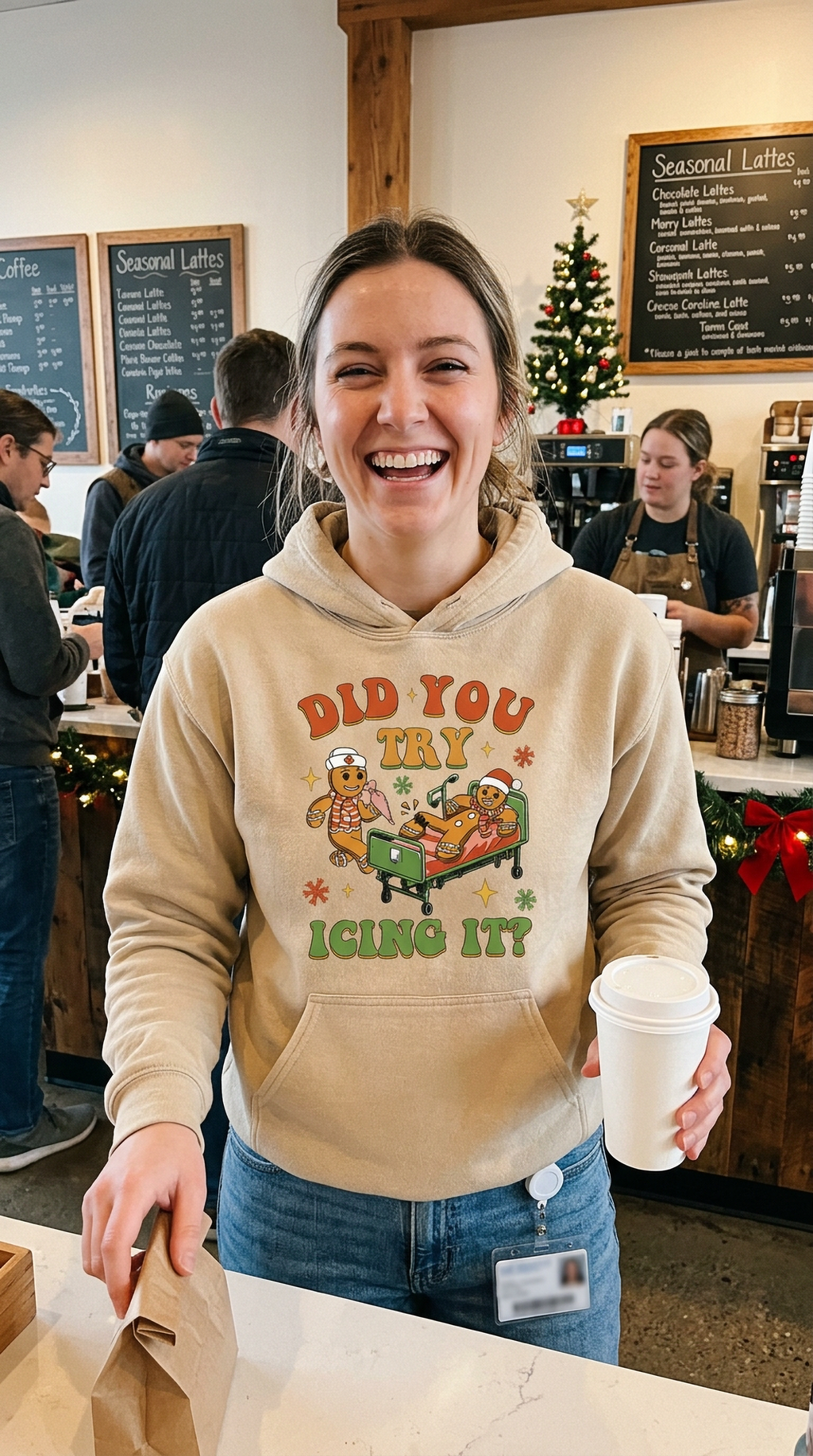 Woman wearing sand Did You Try Icing It gingerbread Christmas hoodie in a healthcare setting