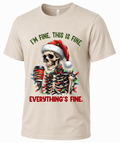 Sand Christmas graphic tee with I’m Fine Everything’s Fine skeleton design and colorful holiday lights
