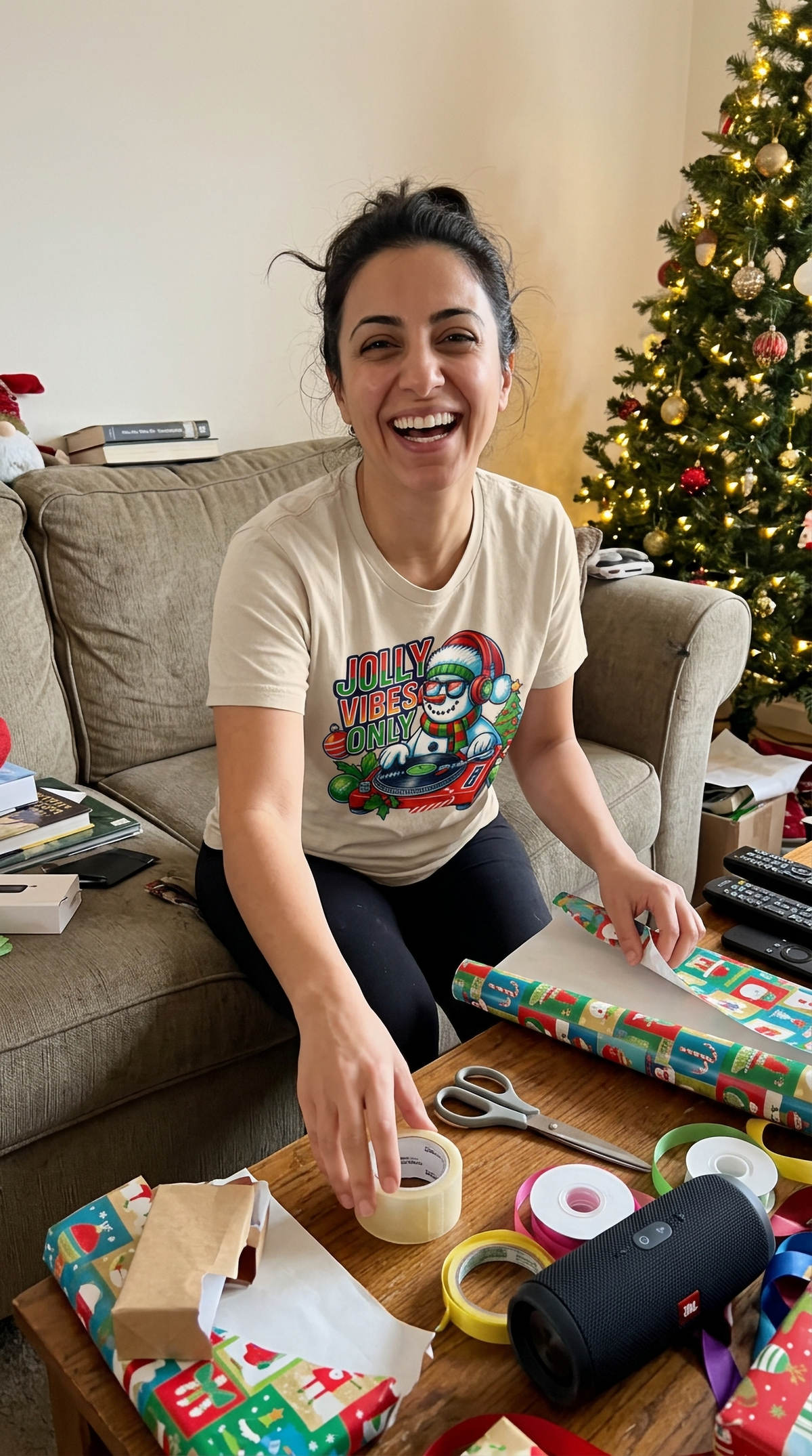 Sand Lifestyle: Person wearing a sand-colored funny Christmas snowman DJ graphic t-shirt.