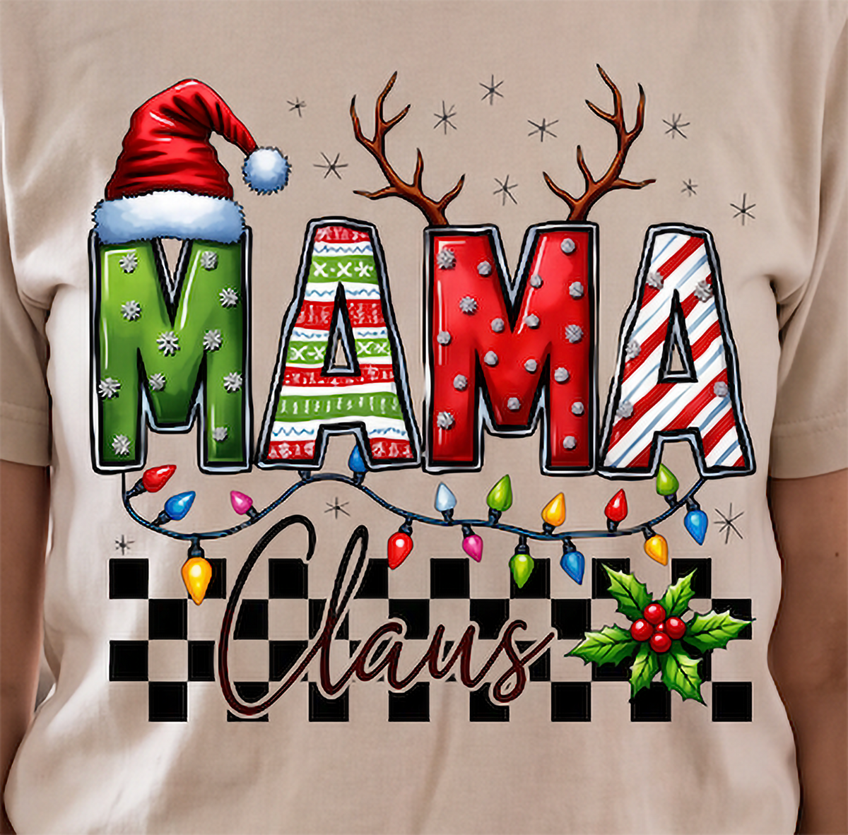 Close-up of sand Mama Claus Christmas shirt featuring colorful MAMA lettering, Christmas lights and checkered design.