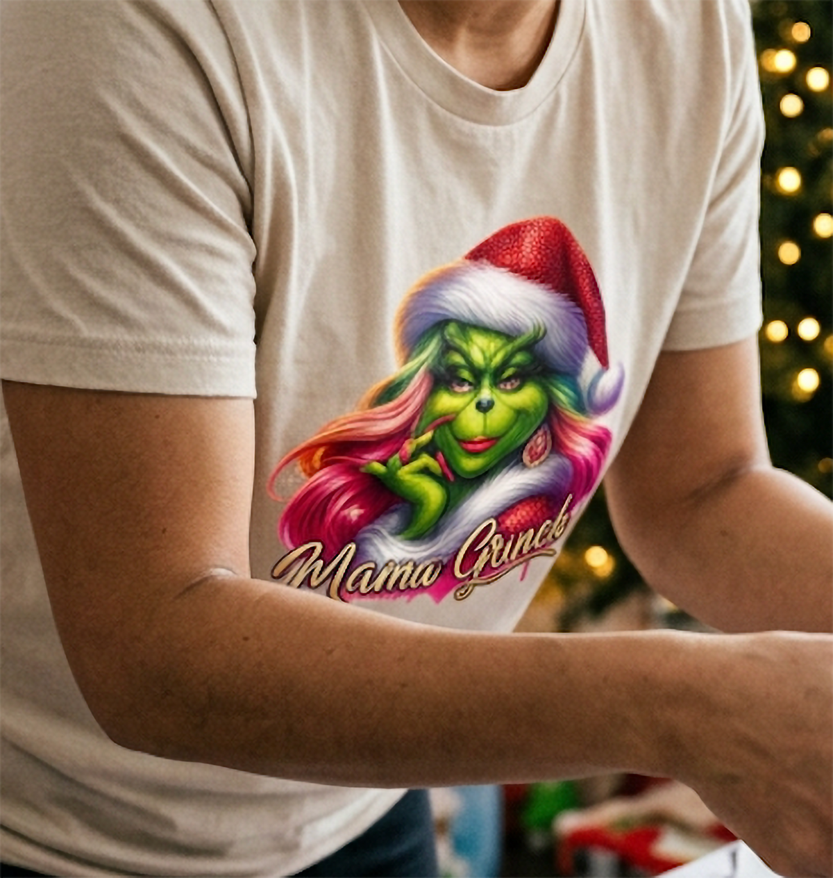 Close-up of sand Mama Grinch shirt showing detailed pink hair, Santa hat and glamorous Christmas character design.