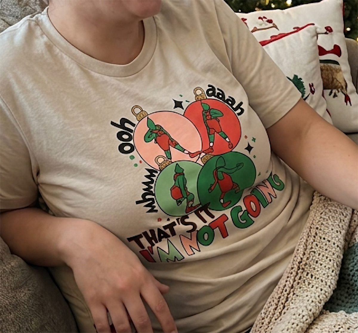Sand Close-Up: Detailed view of the sarcastic That's It I'm Not Going Christmas design printed on a sand-colored shirt.