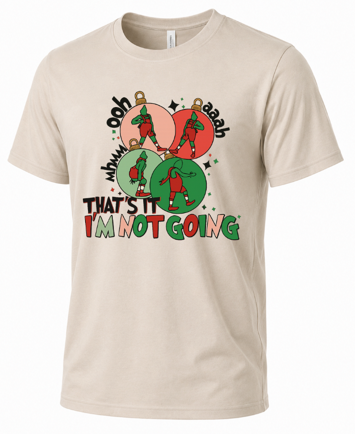 Sand Mockup: Sand-colored unisex Christmas t-shirt featuring playful green holiday characters dancing inside red and green ornaments.