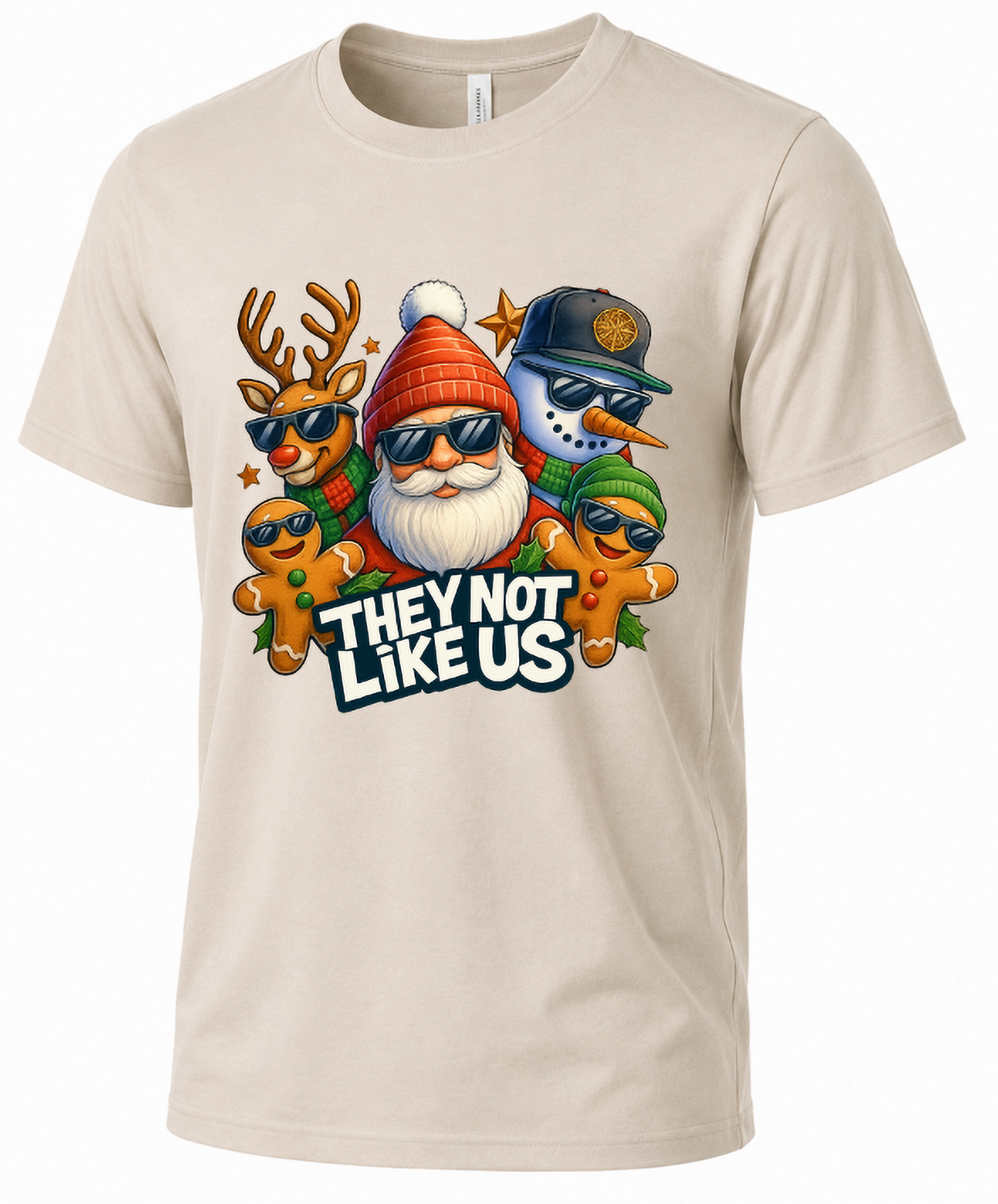 Sand Mockup: Sand-colored unisex Christmas graphic t-shirt featuring Santa, reindeer, snowman, and gingerbread cookies with They Not Like Us lettering.