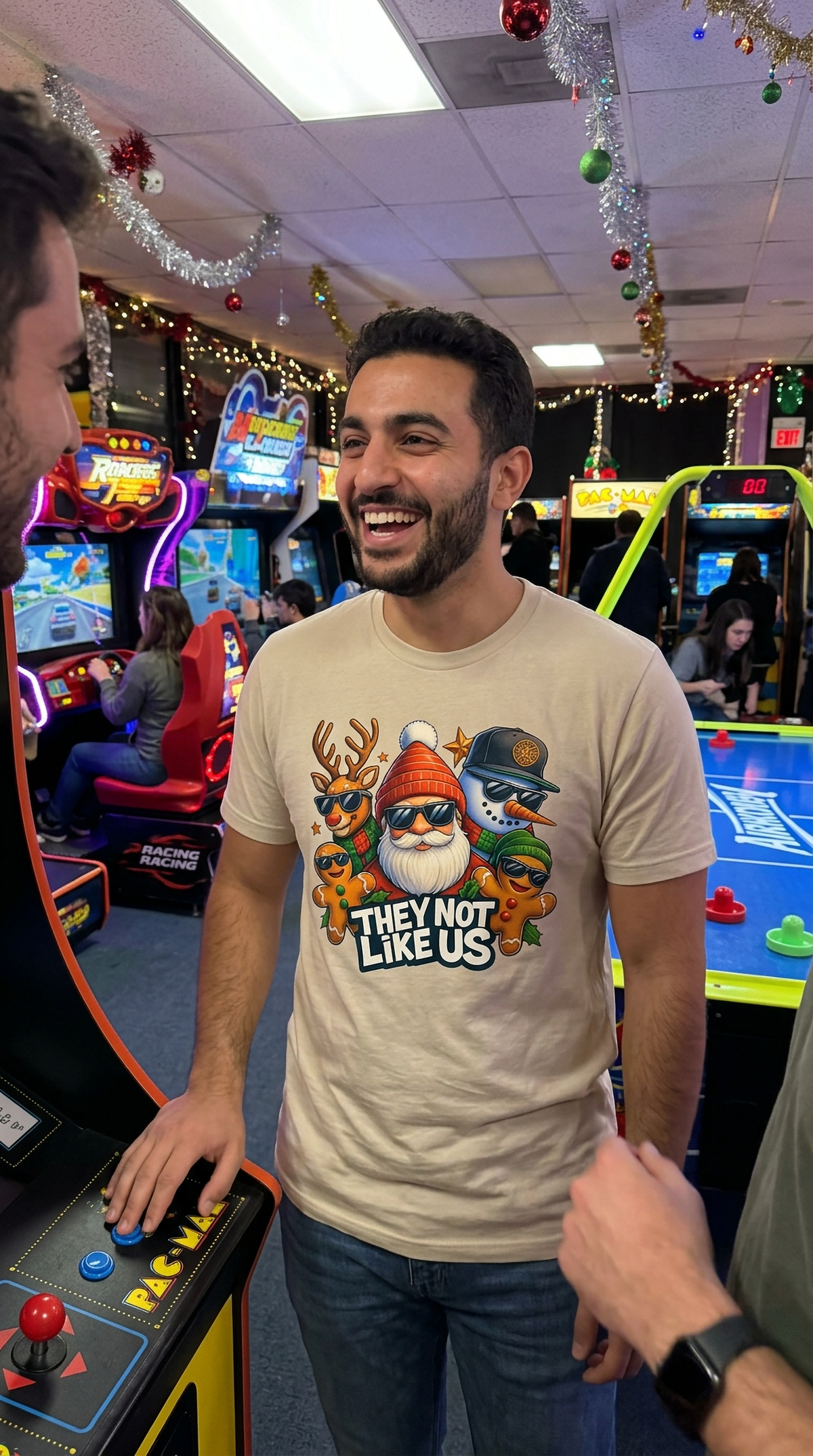 Man wearing sand-colored They Not Like Us Christmas t-shirt while browsing a festive retail store.