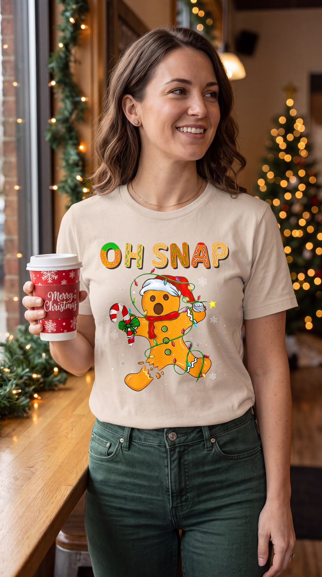 Person wearing sand Oh Snap gingerbread Christmas shirt in a festive lifestyle setting