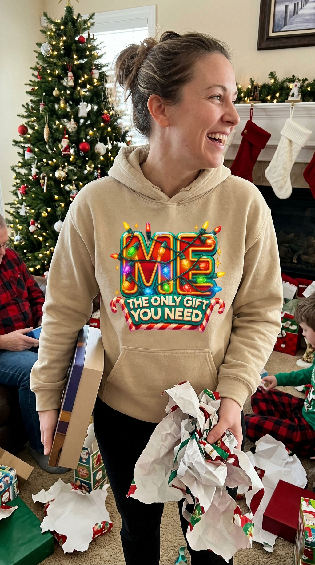 Woman wearing sand Me The Only Gift You Need hoodie for a festive holiday outfit