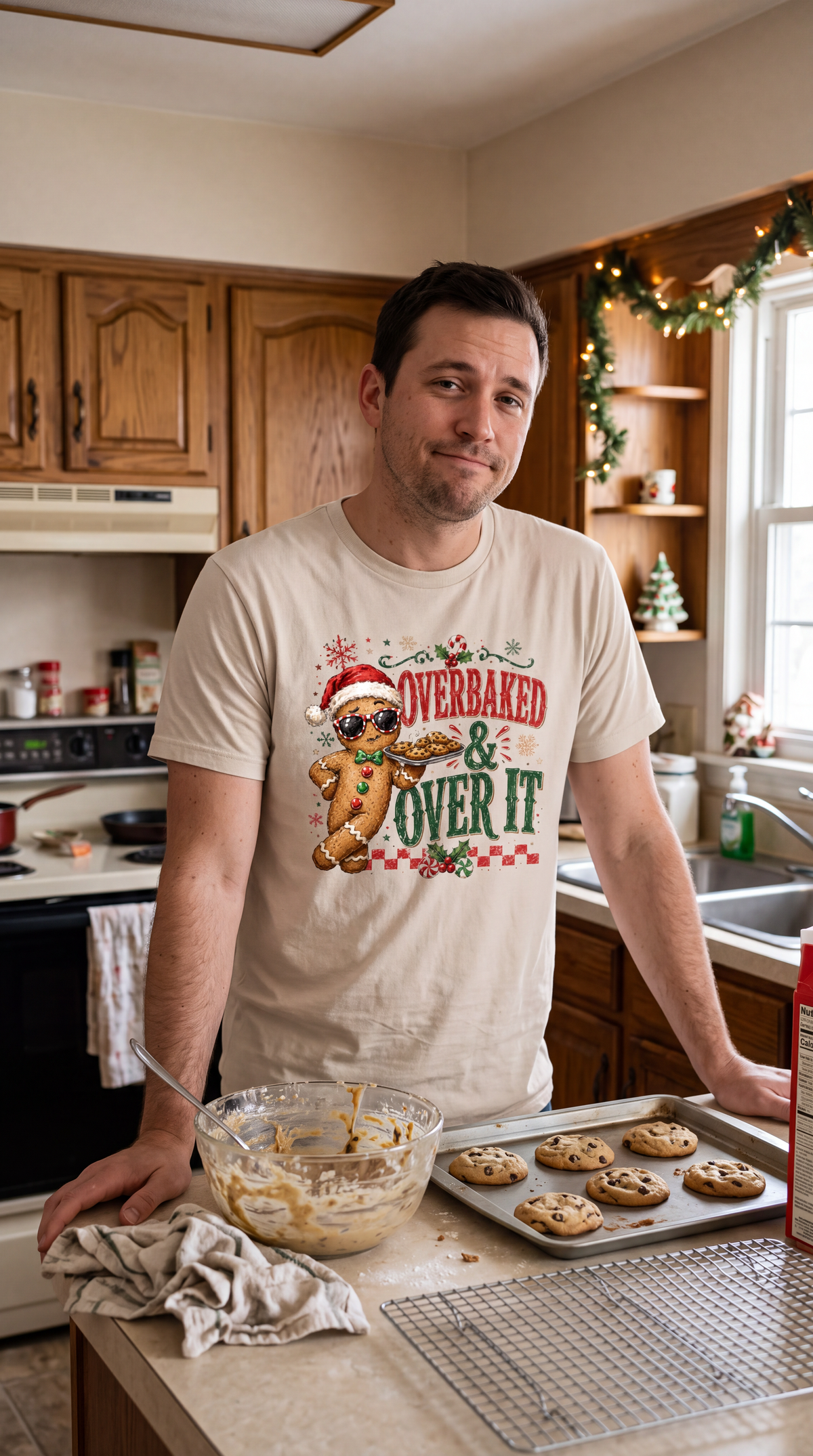 Man wearing sand Overbaked and Over It Christmas shirt with festive gingerbread cookie design.
