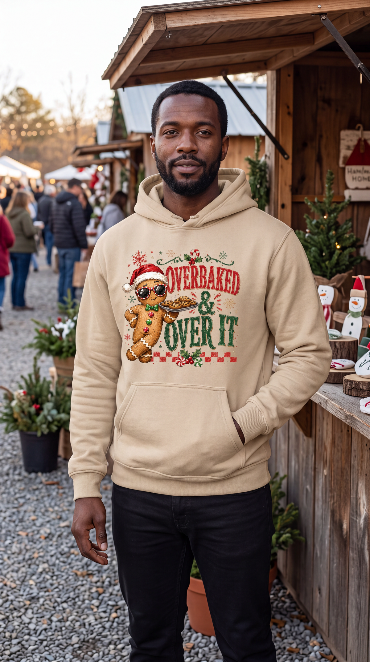 Man wearing sand funny gingerbread Christmas hoodie with Overbaked and Over It design