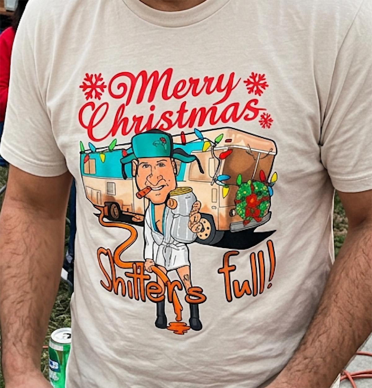 Sand Shirt Mockup: Sand-colored unisex Christmas t-shirt with Merry Christmas lettering, festive camper artwork, and humorous holiday graphic.