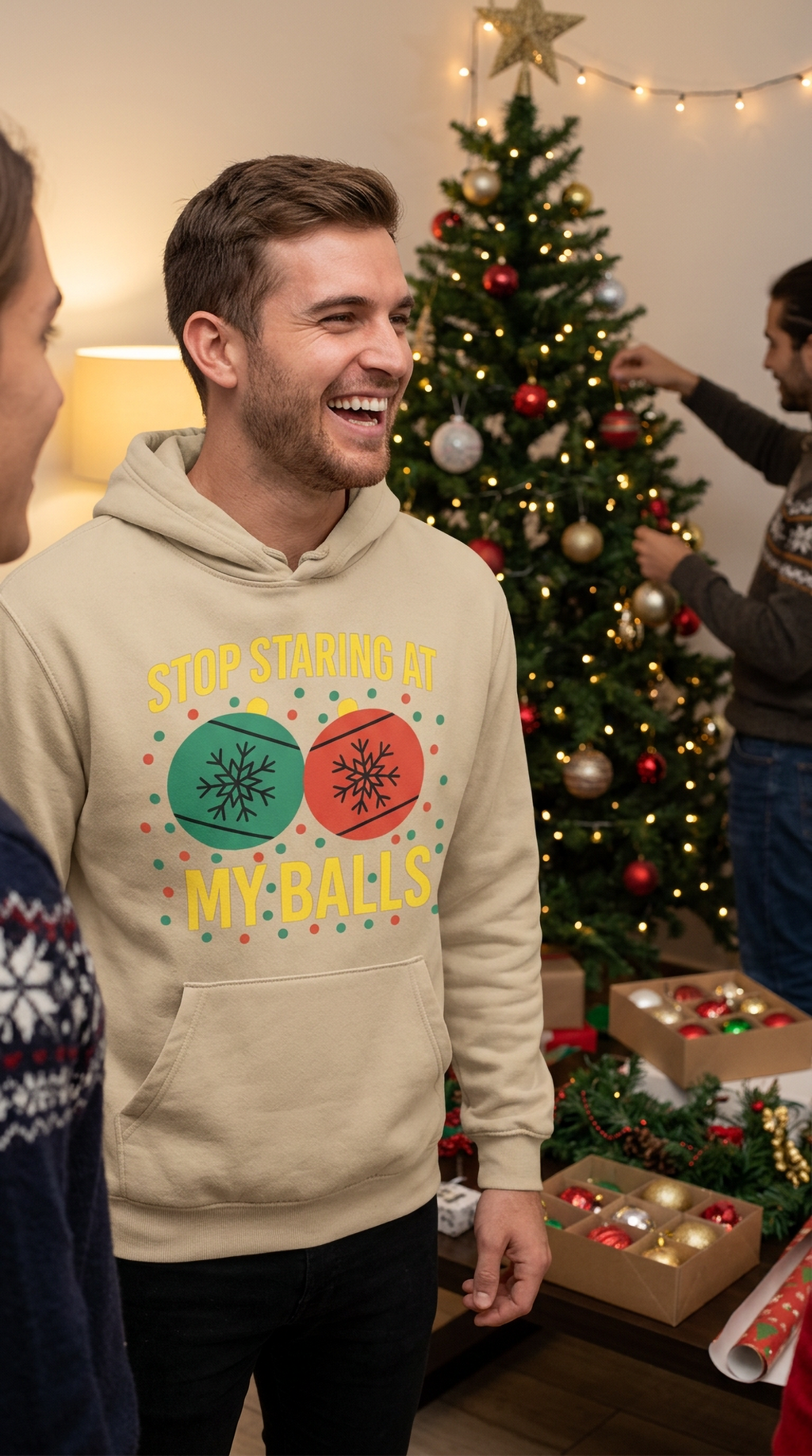 Man wearing sand Stop Staring at My Balls funny Christmas hoodie at a holiday party