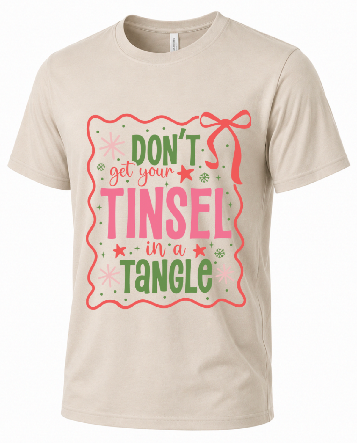 Sand Christmas graphic tee featuring colorful Don’t Get Your Tinsel in a Tangle retro lettering