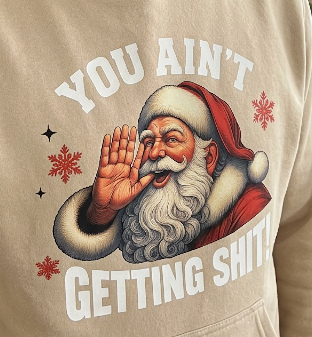 Close-up of You Ain’t Getting Shit Santa graphic on sand Christmas hoodie