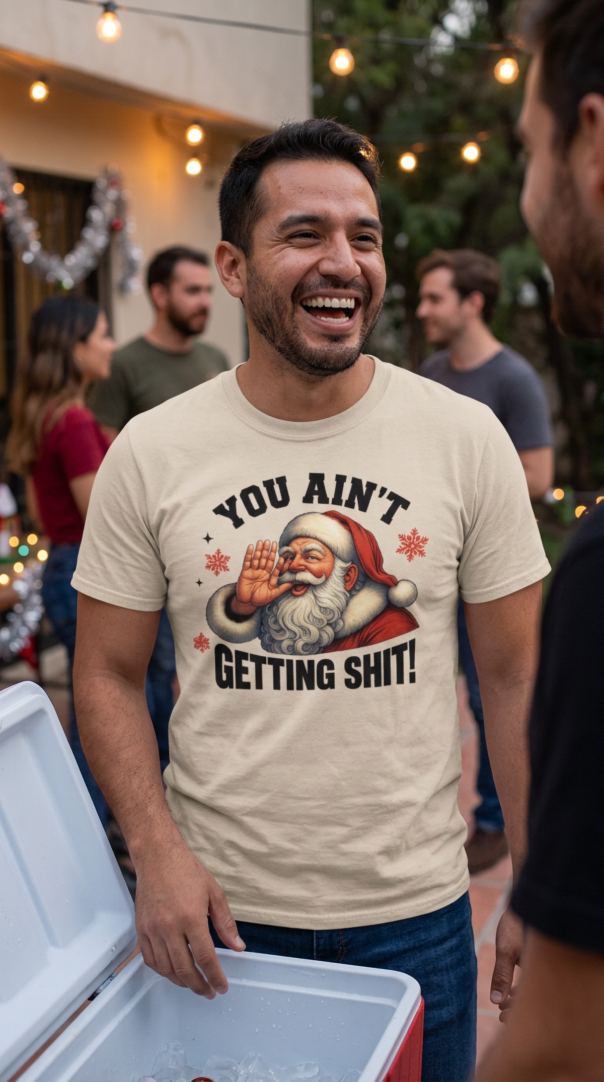 Sand Lifestyle: Man wearing a sand-colored funny Christmas graphic t-shirt featuring a sarcastic Santa Claus holiday design.