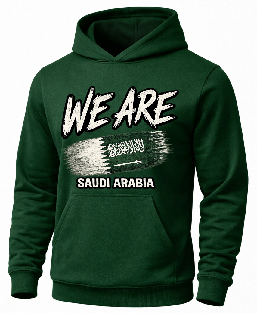 A dark green pullover hoodie with a graphic print on the front. The design features the text 'WE ARE' in a bold, white, brush-stroke style font, followed by a white flag graphic with the words 'SAUDI ARABIA' underneath.