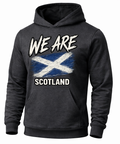 A dark charcoal gray hoodie featuring a distressed graphic print of the Scottish flag with the text 'WE ARE SCOTLAND' in white.