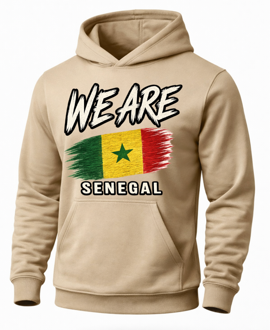 A beige pullover hoodie with a graphic print on the front. The design features the text 'WE ARE' in a black-and-white comic-style font above a distressed Senegalese flag, with 'SENEGAL' printed below in white block letters.