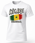 A white short-sleeve crewneck t-shirt featuring a distressed graphic of the Senegalese flag with the text 'WE ARE' above and 'SENEGAL' below, displayed on a clean white background.
