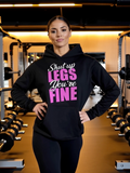 Woman wearing black hoodie with funny gym quote “Shut Up Legs You’re Fine” fitness hoodie in gym